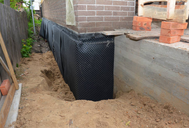 Happy homeowners after waterproofing job in Sweetser